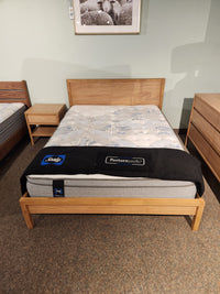 A Palliser EQ3 Marcel Queen Bedframe with nightstand, dresser, and mattress featured in a showroom display.