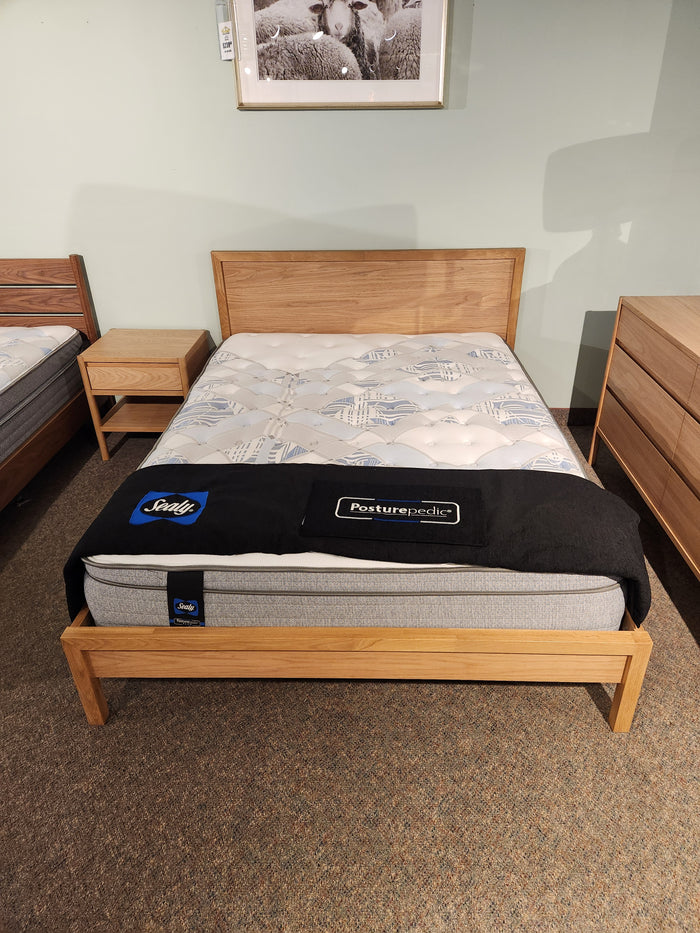A Palliser EQ3 Marcel Queen Bedframe with nightstand, dresser, and mattress featured in a showroom display.