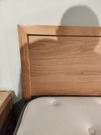 A Palliser EQ3 Marcel Queen Bedframe with a wood veneer headboard and white mattress is partly visible in front.