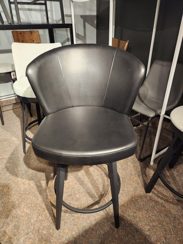 The Amisco 41336 Benson Swivel Stool features black upholstery and metal legs, ideal for modern, carpeted spaces.