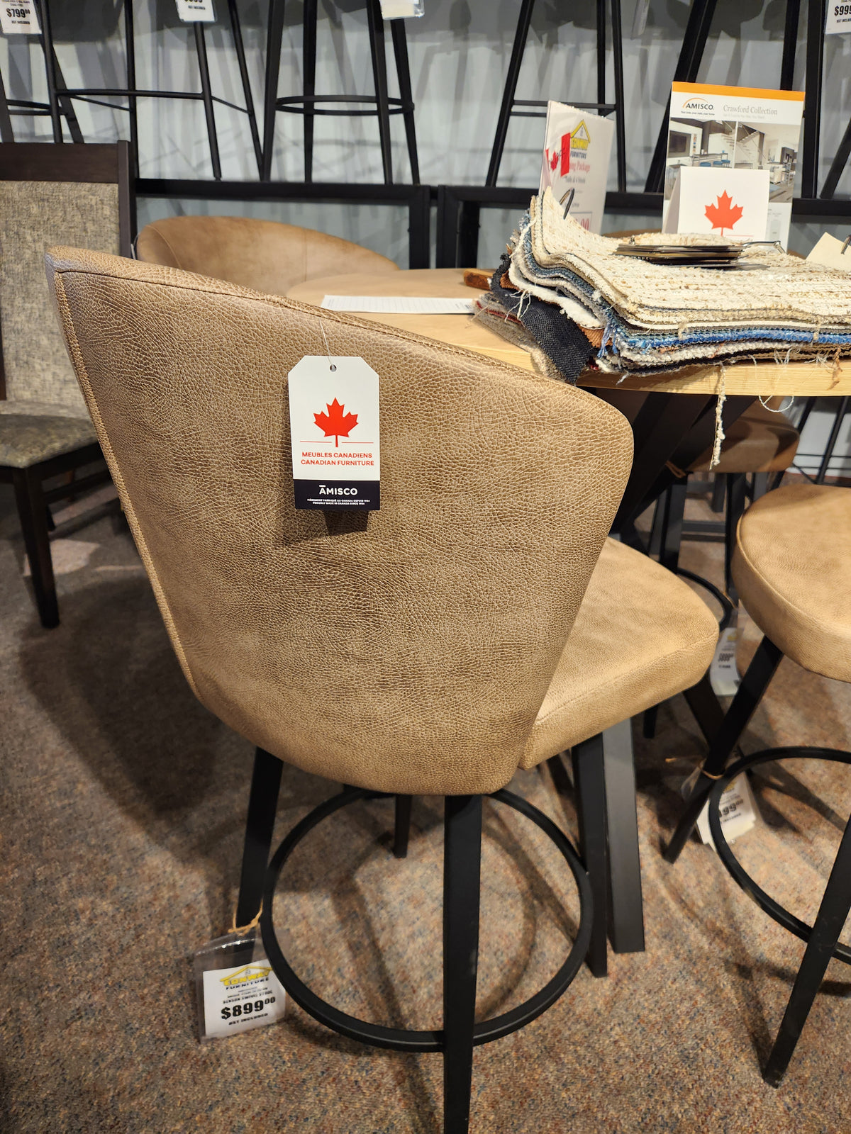 Amisco 41336 Benson Swivel Stool: tan upholstery, black legs—modern and comfy; fabric samples available nearby.