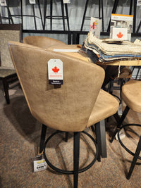 Amisco 41336 Benson Swivel Stool: tan upholstery, black legs—modern and comfy; fabric samples available nearby.