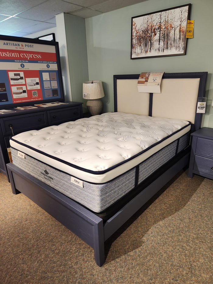 The KingsDown Radiance Elite 2 ET Plush Mattress in queen size on a dark blue frame offers cooling comfort.