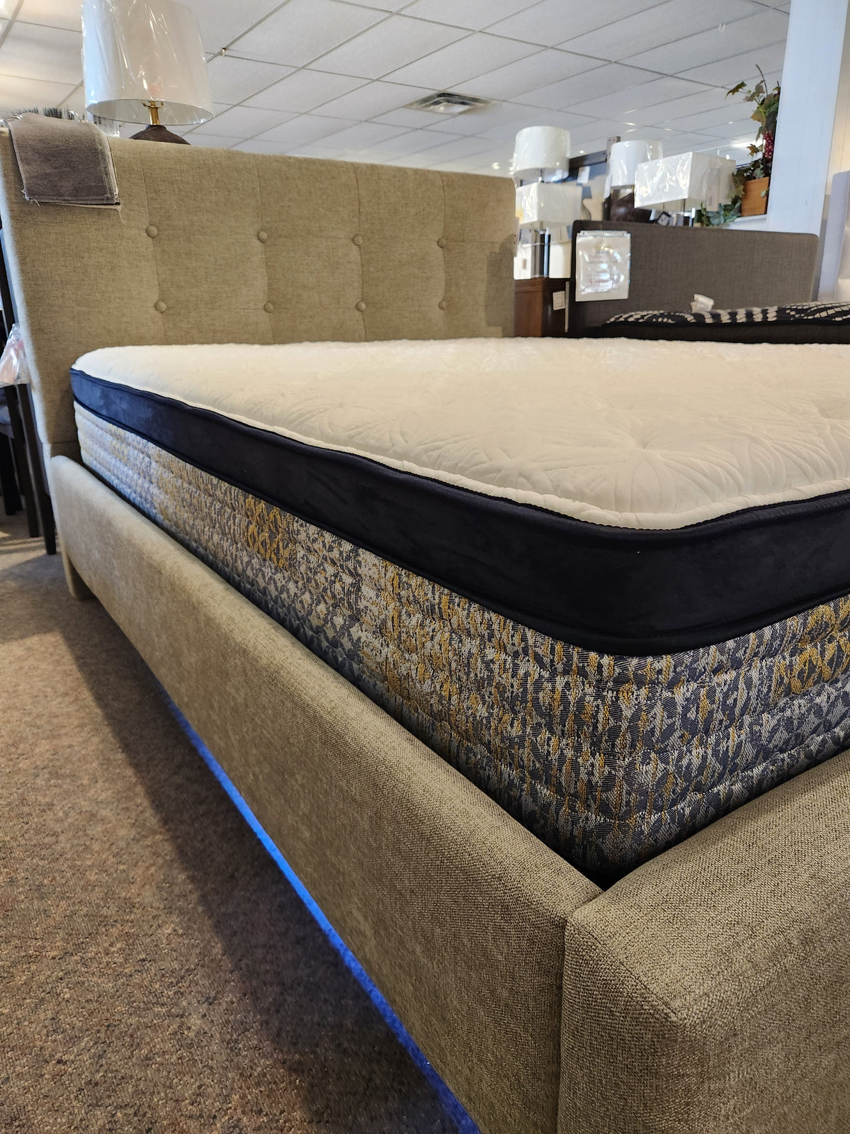 KingsDown Garland ET Plush Mattress on a beige bed frame with blue under-bed lighting for a cooler sleep environment.
