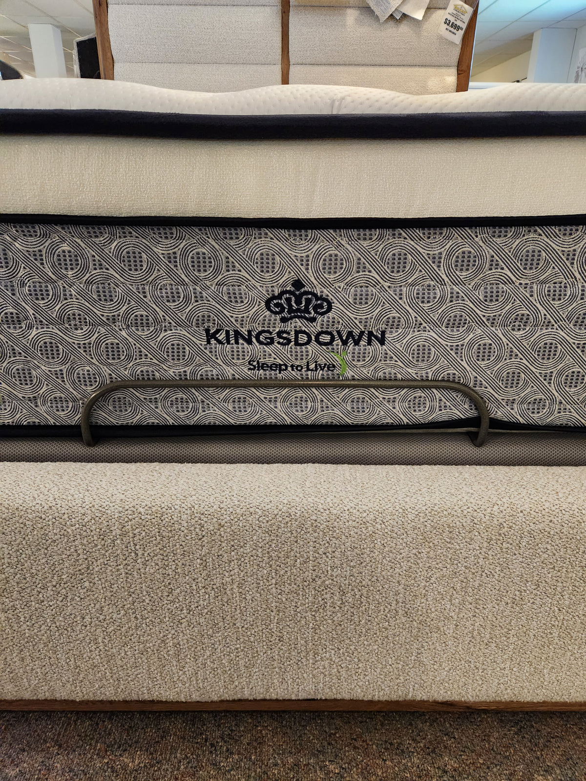 A close-up of the KingsDown Radiance 2 ET Firm Mattress showcases its pressure relief and stylish patterned side panel.