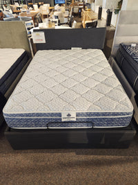 The KingsDown Rio 2 ET Medium Mattress is displayed on a bed frame in the showroom.