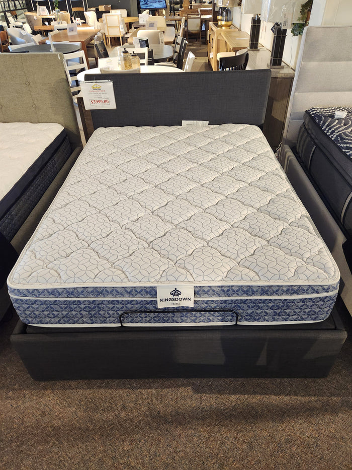 The KingsDown Rio 2 ET Medium Mattress is displayed on a bed frame in the showroom.