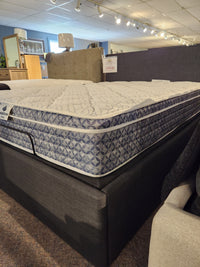 The KingsDown Rio 2 ET Medium Mattress offers comfort and support with a blue and white cover, shown on a platform bed.