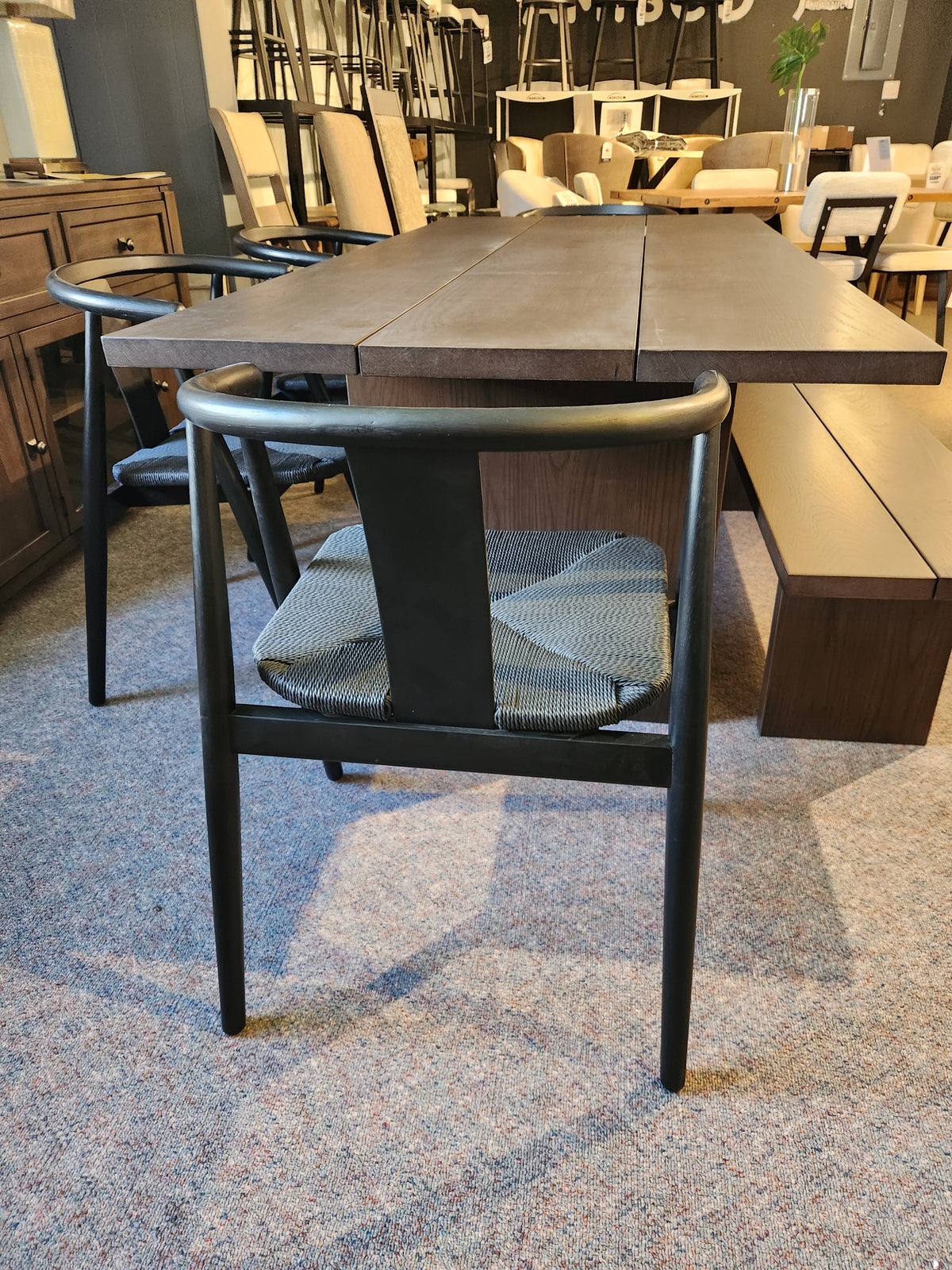 The Palliser EQ3 Homework 5 Piece Dining Table Set is displayed in a furniture showroom.