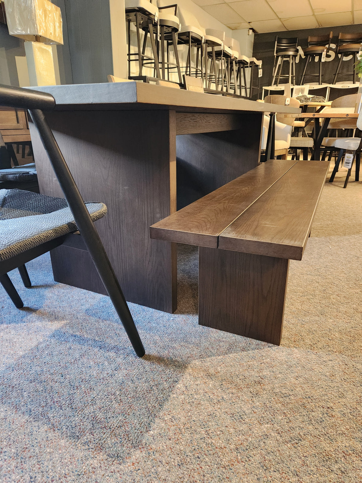 Palliser EQ3 Homework 5 Piece Dining Table Set with matching bench and chairs displayed on carpet in a showroom.