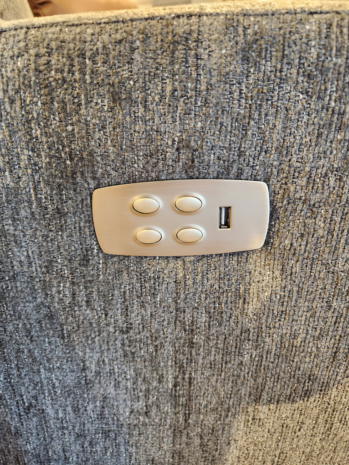 Four buttons and a USB port accent La-z-boy’s 767 Casey Power Rocker Recliner in textured gray fabric.