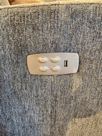 Four buttons and a USB port accent La-z-boy’s 767 Casey Power Rocker Recliner in textured gray fabric.