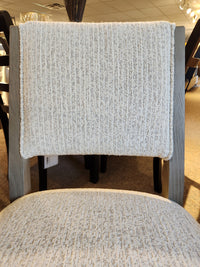 Close-up of the Magnussen Braelyn D5874 5-piece dining package with padded chairs in light gray fabric and pine frame.