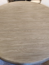 Magnussen Braelyn D5874 60" round dining set in light pine, shown from above with natural wood grain finish.
