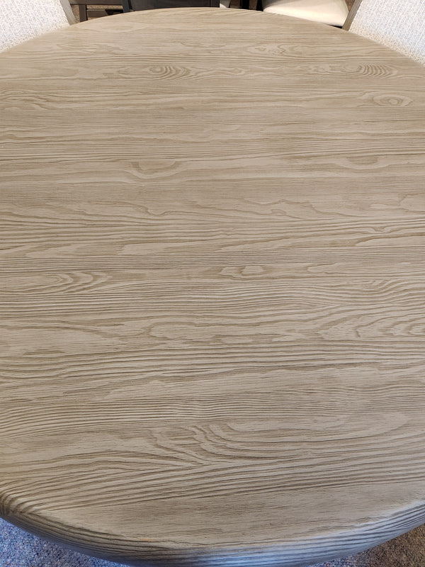 Magnussen Braelyn D5874 60" round dining set in light pine, shown from above with natural wood grain finish.