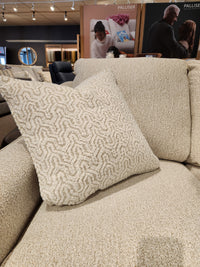 A beige textured throw pillow accents the Decor-rest 2981 Loveseat with box seat cushions in a showroom.