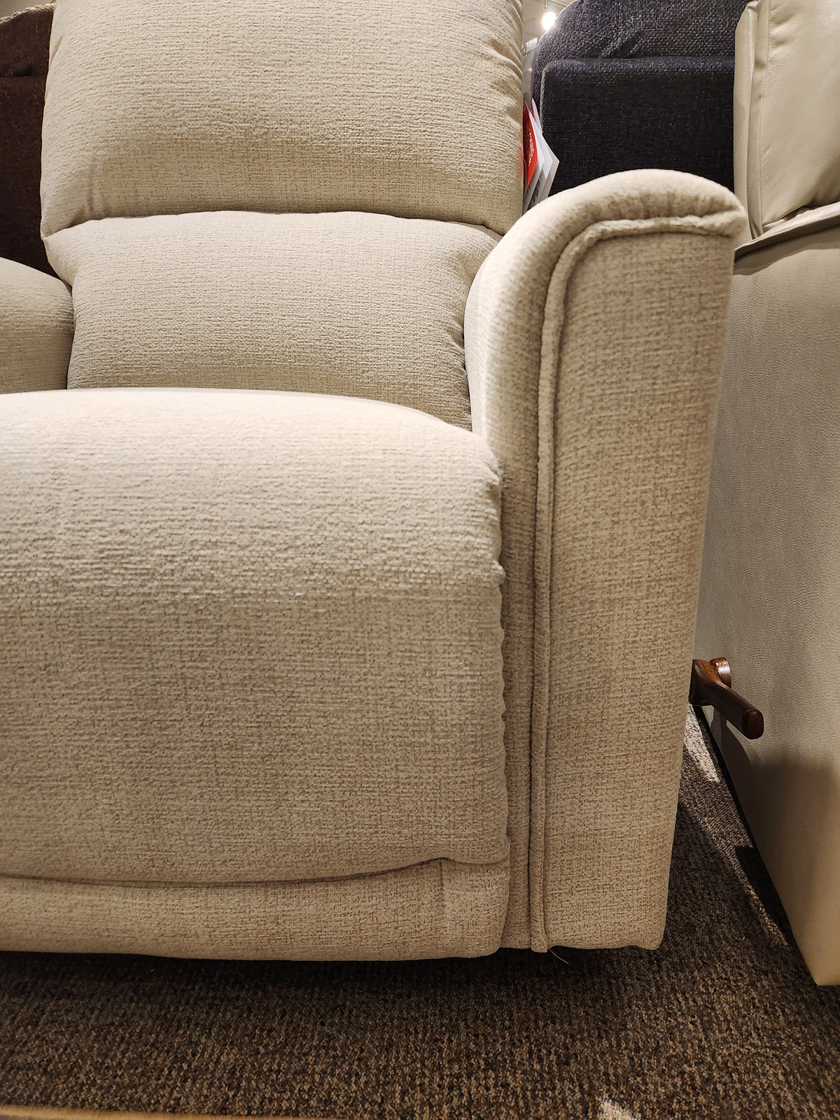The La-Z-Boy 803 Cade Rocker Recliner is a beige upholstered chair with a visible lever, seen on a brown carpet.