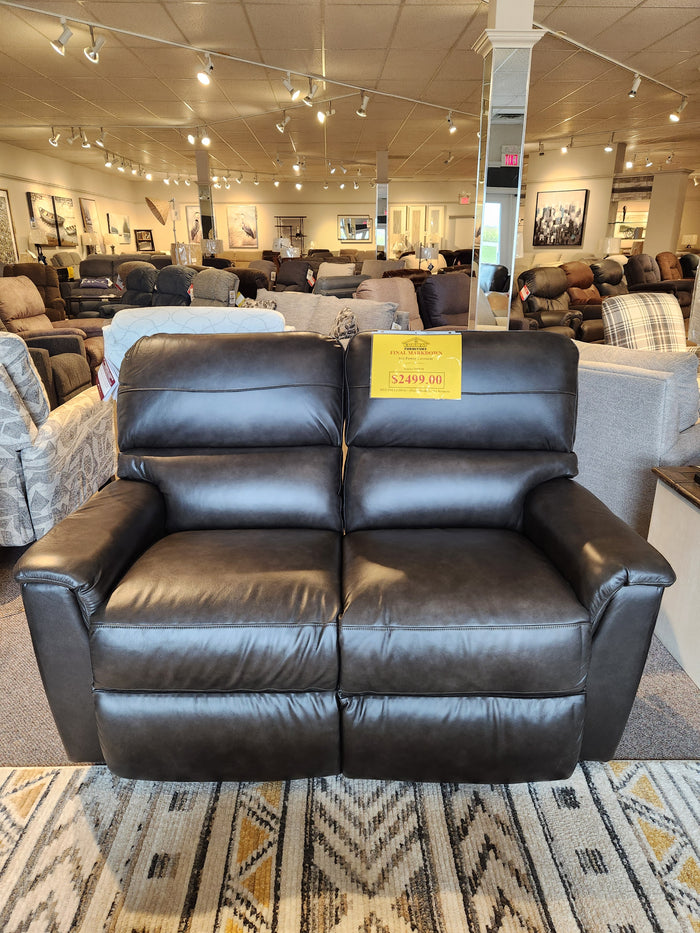 A La-z-boy 769-U48 Ava Power Loveseat in black leather reclines, priced at $2499 in the showroom.