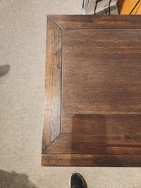Close-up of a Jofran Gramercy 4 Door Accent Cabinet with mitered corners, set on a beige carpeted floor.