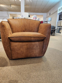 752 Swivel Chair by Leather Craft on carpeted showroom floor, surrounded by decor items in the background.