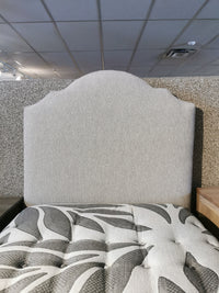830 Upholstered Twin Bed by Vaughan Bassett in Tide & Timber store; headboard speckled, mattress with leaf design.