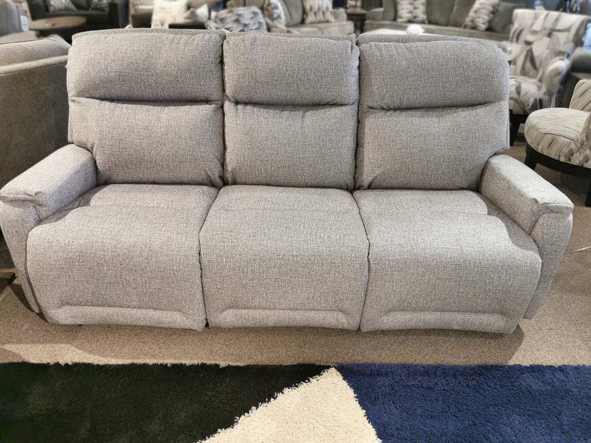 S650RZ4 Derek Power Sofa by Best, a gray three-seater recliner, on display in a furniture showroom.