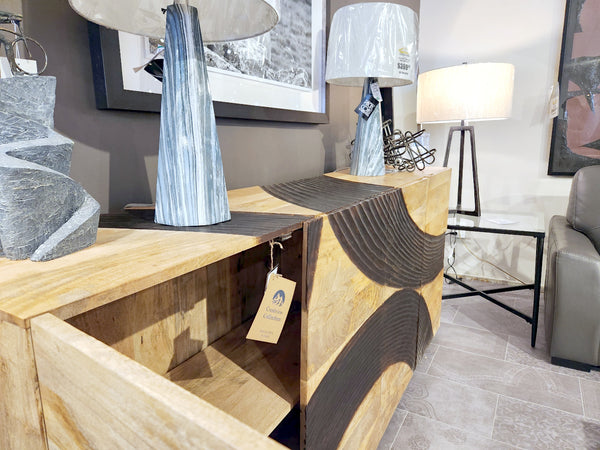 Crestview Collection 4593 Lennox 4 Door Sideboard with wave accents and two table lamps in a furniture showroom.