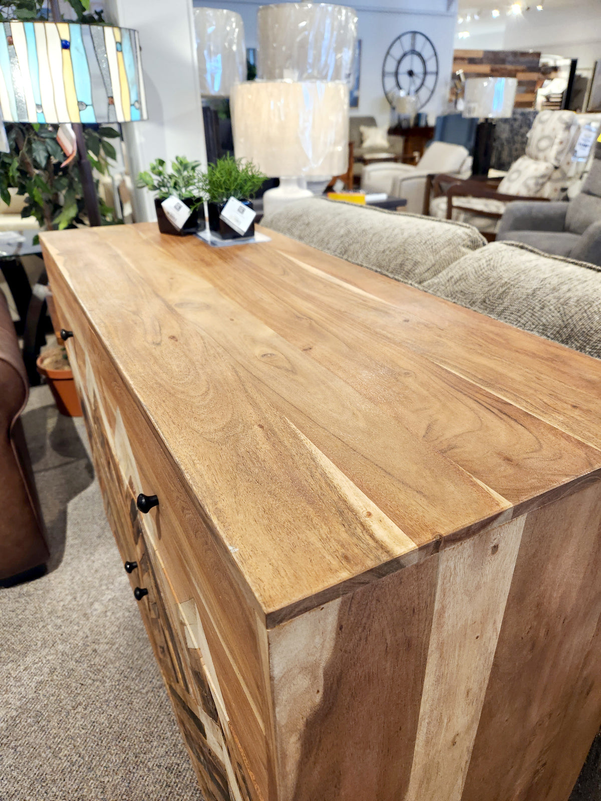 A Crestview Collection Sierra Nevada Cabinet is displayed in a furniture showroom.