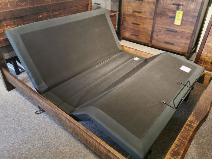 Oasis Adjustable Base on display, dark cover, partially raised with head massage for relaxation. (Brand: Fashion).