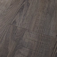 Close-up of Mannington Adura Flex Sausalito Waterfront—textured dark brown planks with visible grain and natural patterns.
