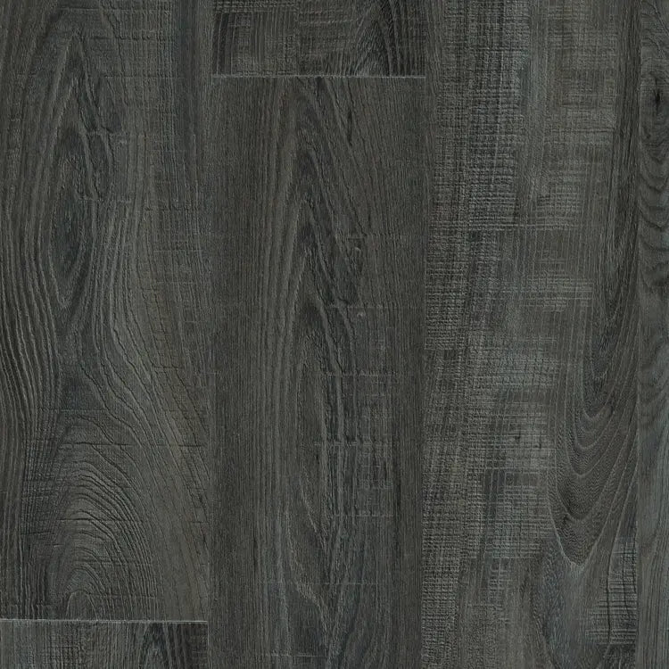 Close-up of Mannington Adura Flex Sausalito Waterfront flooring in dark gray with textured, vintage wood plank patterns.