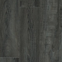 Close-up of Mannington Adura Flex Sausalito Waterfront flooring in dark gray with textured, vintage wood plank patterns.