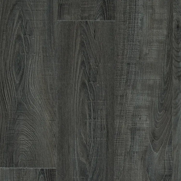 Close-up of Mannington Adura Flex Sausalito Waterfront flooring in dark gray with textured, vintage wood plank patterns.
