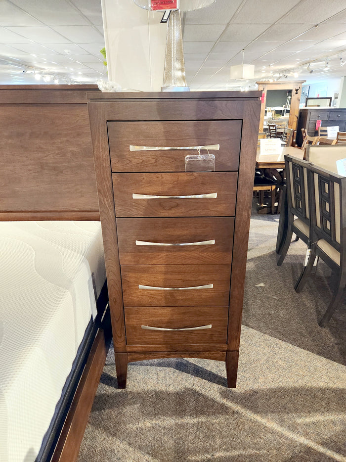 Handstone CA25 Catalina 5-Drawer Chest with transitional style, shown beside a bed in a furniture store.