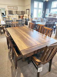 The Handstone RA4284 Rafters Dining Package with rustic chairs is showcased among industrial furniture in the showroom.