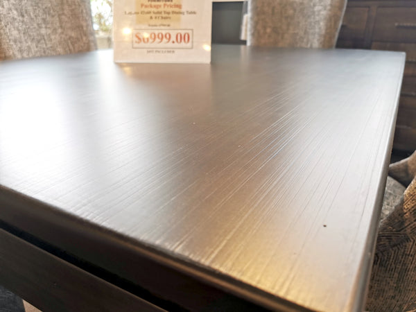 Close-up of a Handstone LA426 Laguna Dining Package with a $999.00 price sign in the background.