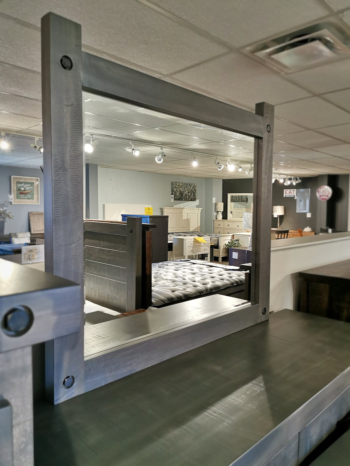 The Handstone Rafters Six Drawer Dresser Mirror adds rustic style to the furniture store display.