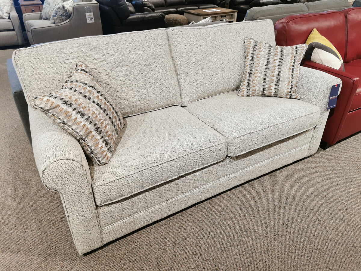 Simmon 930-62 Double Sofa Bed by Simmons Upholstery with two patterned pillows, shown beside a red couch in showroom.