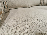 Close-up of a textured beige Simmons Upholstery Simmon 930-62 Double Sofa Bed with two patterned cushions in back.