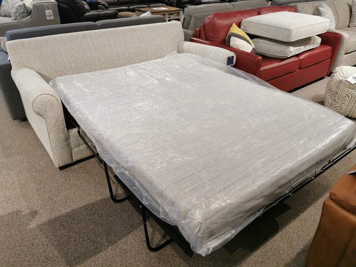 The Simmons Upholstery Simmon 930-62 Double Sofa Bed with a memory foam mattress is displayed in the showroom.