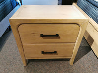 Magnussen B5684 Somerset Nightstand with two drawers, black handles, on carpet by the bed.