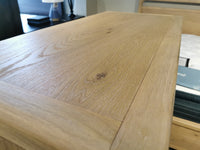 A close-up of the B5684 Somerset Drawer Chest by Magnussen shows its knotty white oak veneer grain and knots.