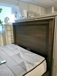 Bedroom showroom with Vaughan Bassett's 11 Fundamental Panel Double Bed, mattress, dresser, lamps, and window.