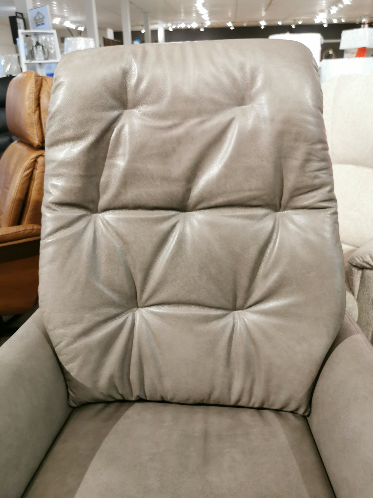 A close-up of the Ambiente Chairs Vega Power Recliner featuring button-tufted Italian leather and plush high-density foam.