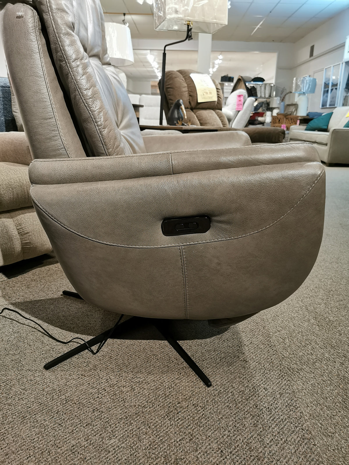 Side view of the Vega Power Recliner by Ambiente Chairs, featuring a motion Italia mechanism in a furniture store.