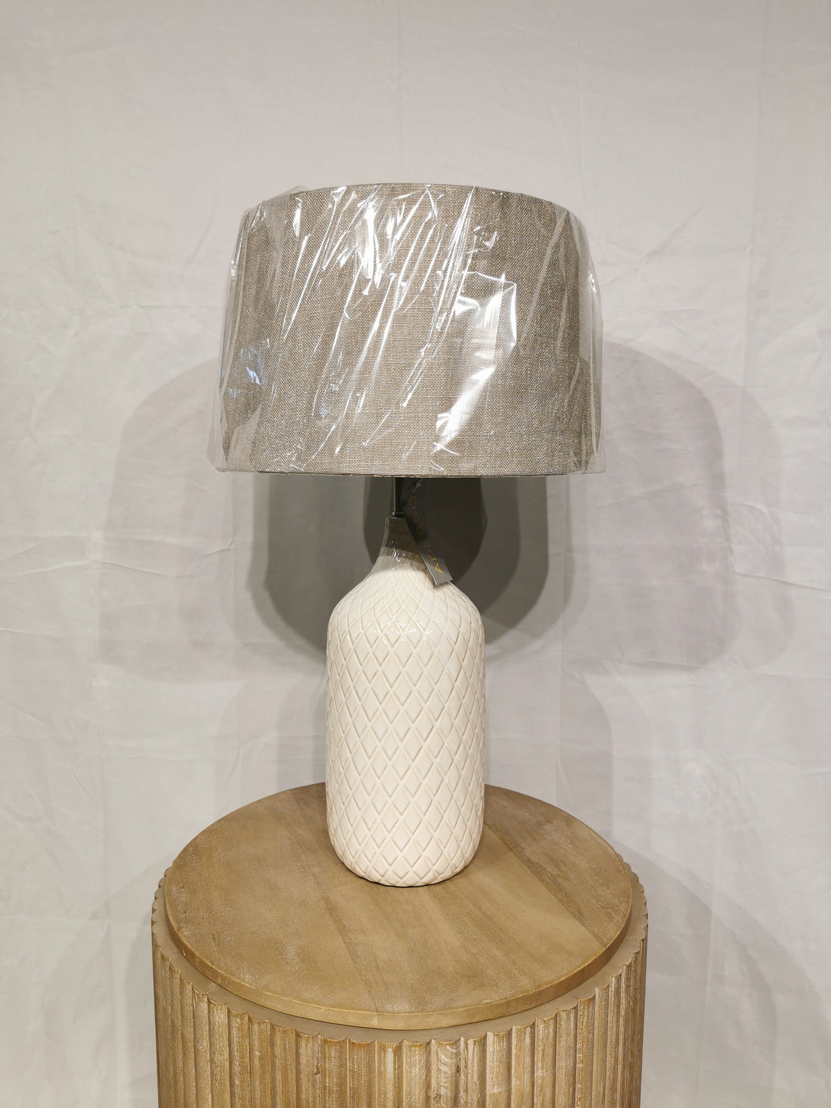 The Kathryn 2 Pack Table Lamp by Adesso Lamp with a beige shade is ideal home decor for any round wooden table.