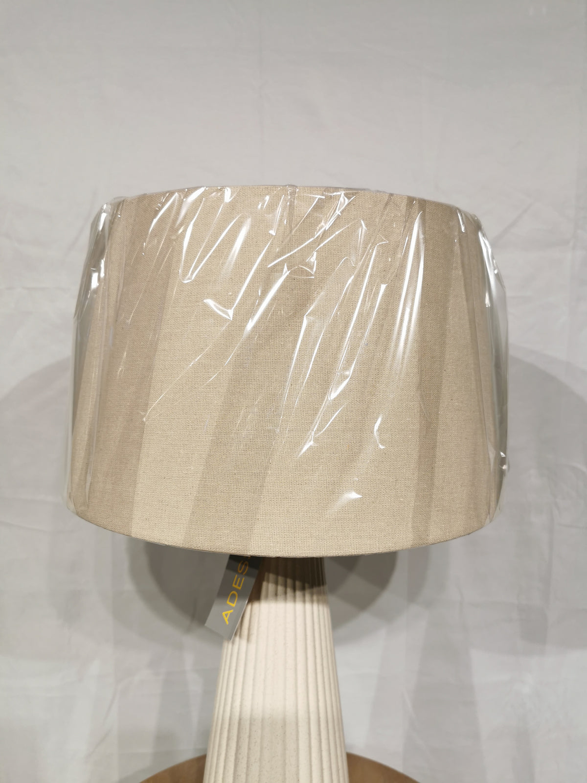 Adesso Lamp Lana 2 Pack: off-white ribbed ceramic table lamps with oatmeal linen pleated shades, wrapped in plastic.