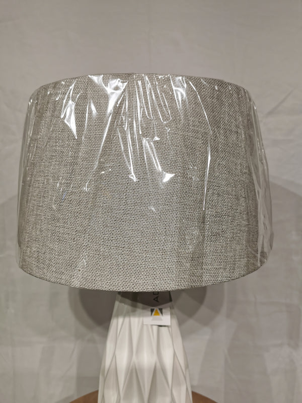 The Adesso Lamp Joan 2 Pack Table Lamp features a ceramic base and fabric shade with protective plastic, shown on plain background.