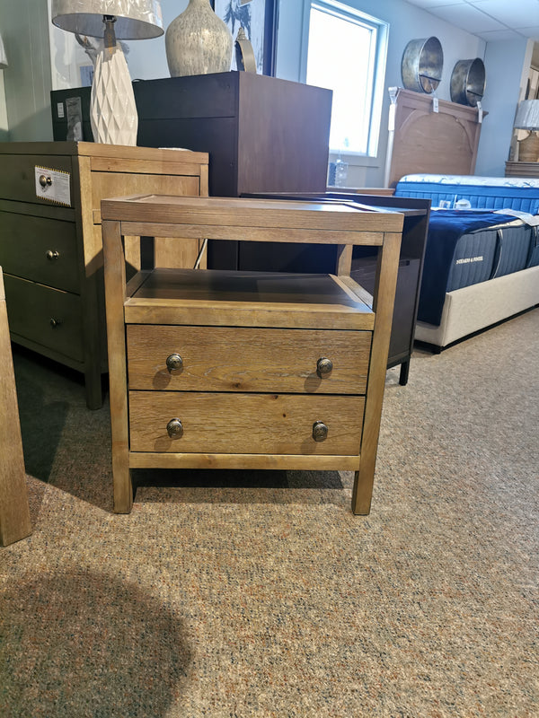 The Donald Choi Winston 2 Drawer Nightstand features solid wood and an open shelf, perfect for stylish showrooms.