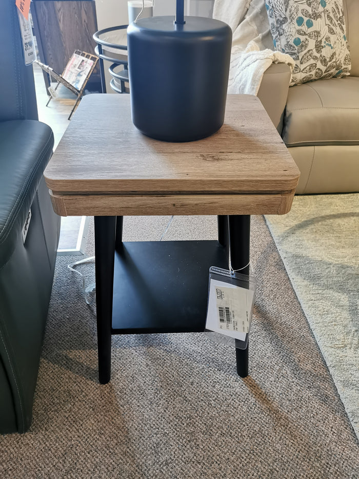The Magnussen Fletcher End Table, T5864, with a driftwood finish and black lamp, enhances the living room aesthetic.